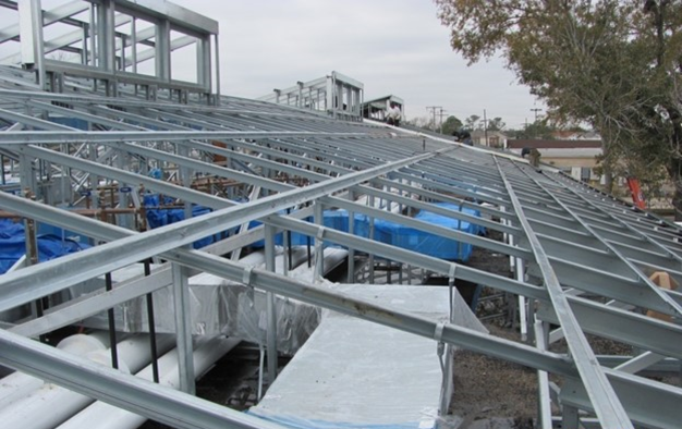 Frame-up metal retrofit system designed to improve roof slope and drainage