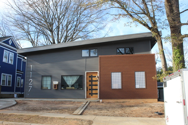 Charcoal corrugated metal roof and wall panel installed on a building exterior